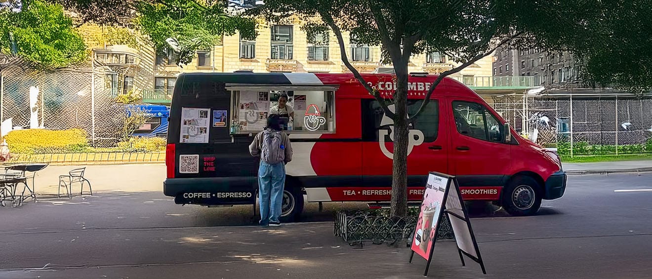 Coffee Malem coffee truck serving espresso to a guest in a city park