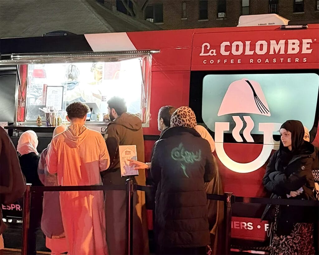 Guests ordering from the Coffee Malem coffee truck at an evening event in Clifton, New Jersey
