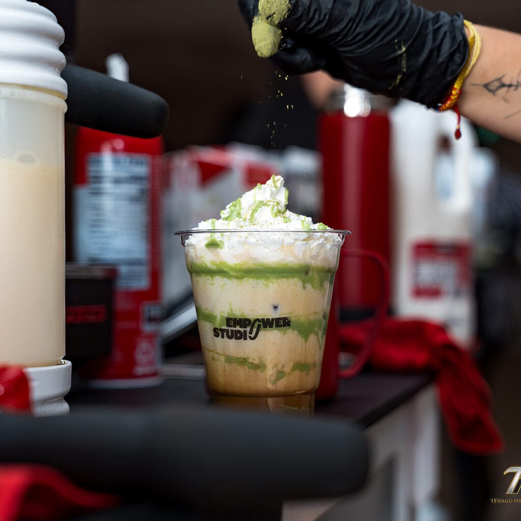 Coffee Malem barista finishing a specialty iced drink at an Empower Studio event in New Jersey