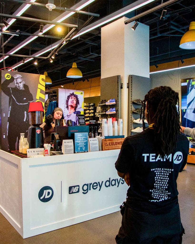 Coffee Malem barista operating a branded coffee station at a Grey Days retail activation in New York City