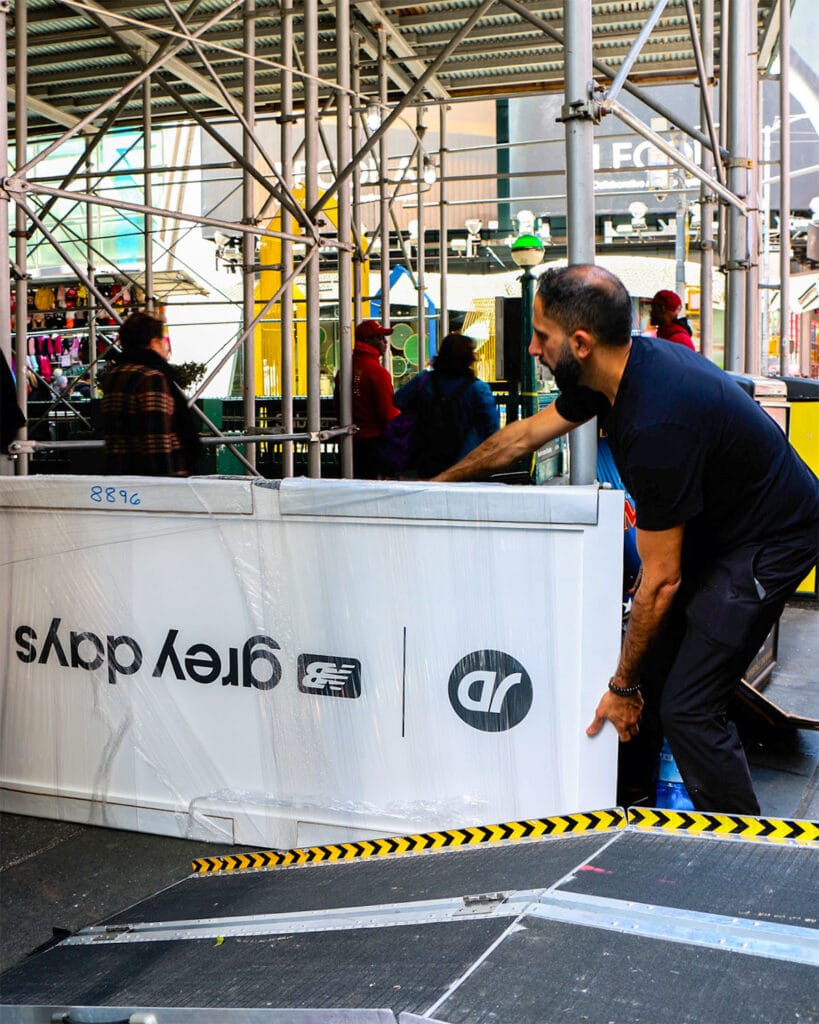 Coffee Malem team moving a branded coffee service counter during event setup in New York City