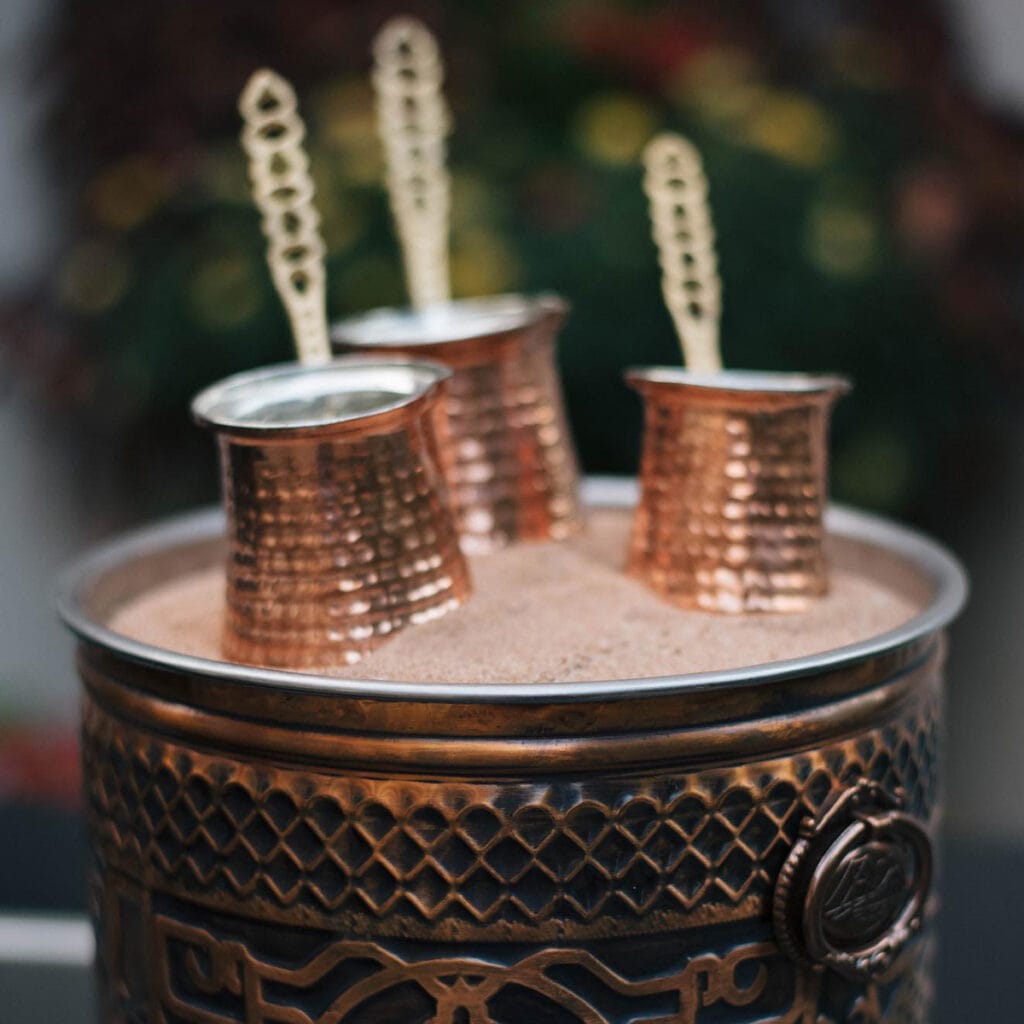 Turkish coffee pots prepared on hot sand at a Coffee Malem event